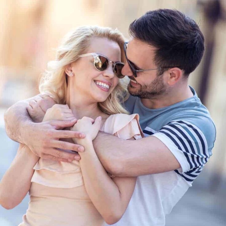 Couple hugging on a sunny day.