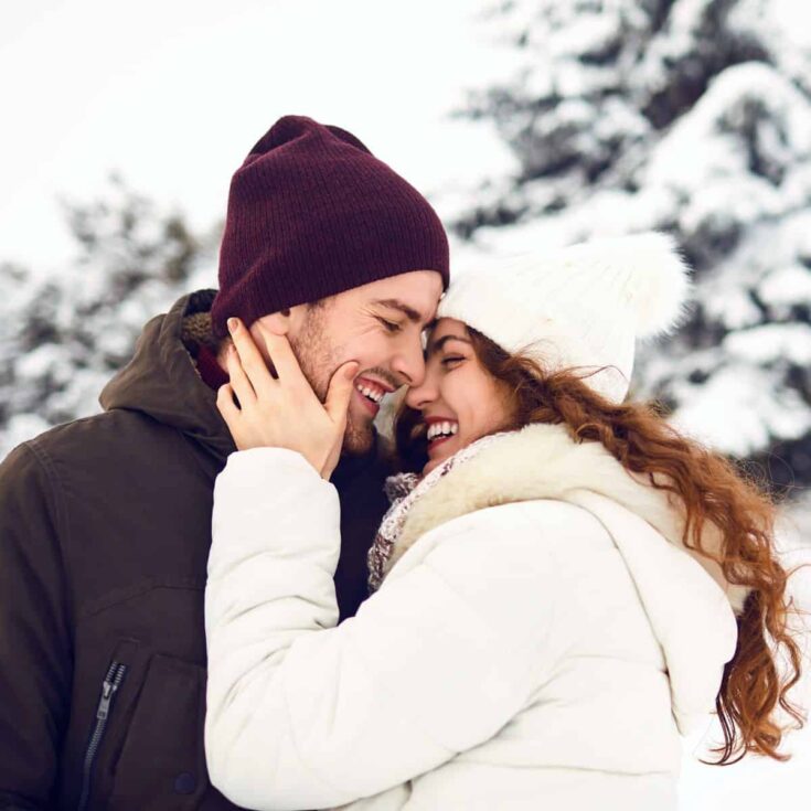 A couple being intimate while enjoying winter together after reading these fun winter date ideas