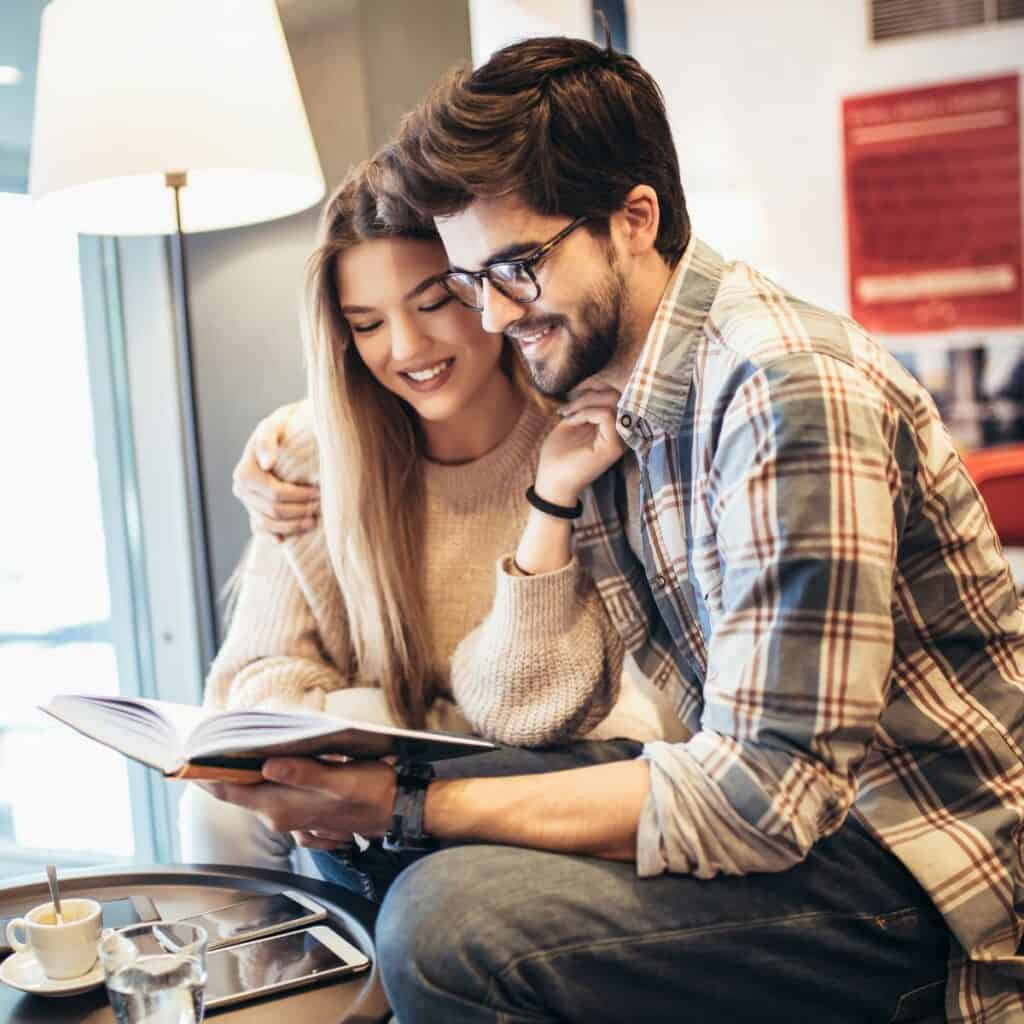 Couple sharing fave children's book: one of the library date ideas.