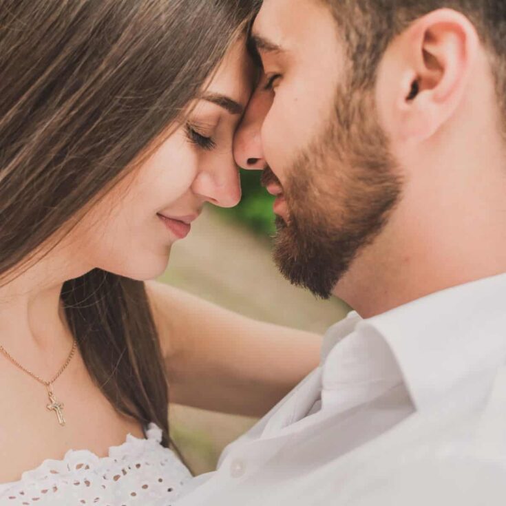 A sweet couple facing each other with the girl using the love language of words of affirmation for him