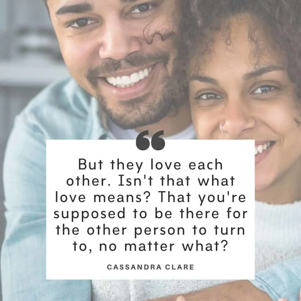 A black couple holding each other with a marriage is hard quotes overlay by Cassandra Clare.