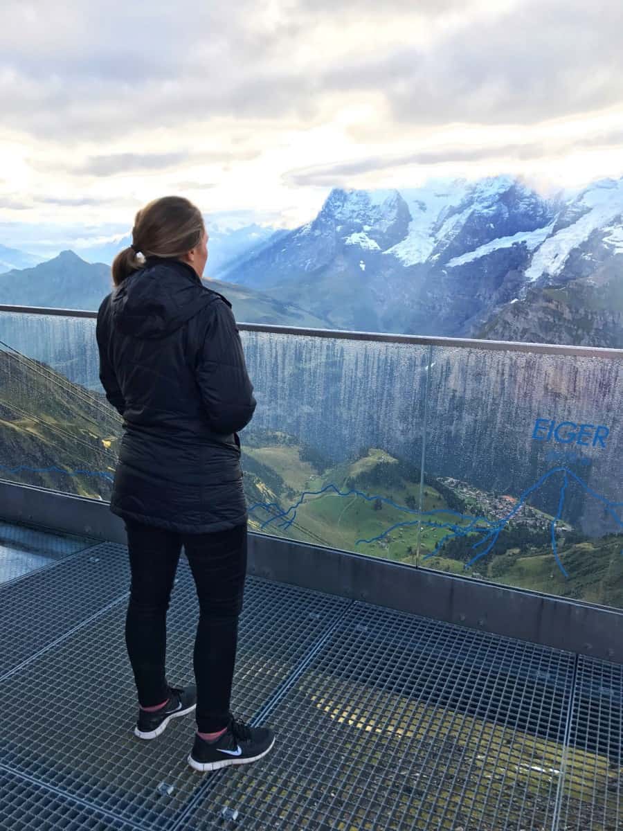 Woman looking at the Swiss Alps while traveling as a couple.