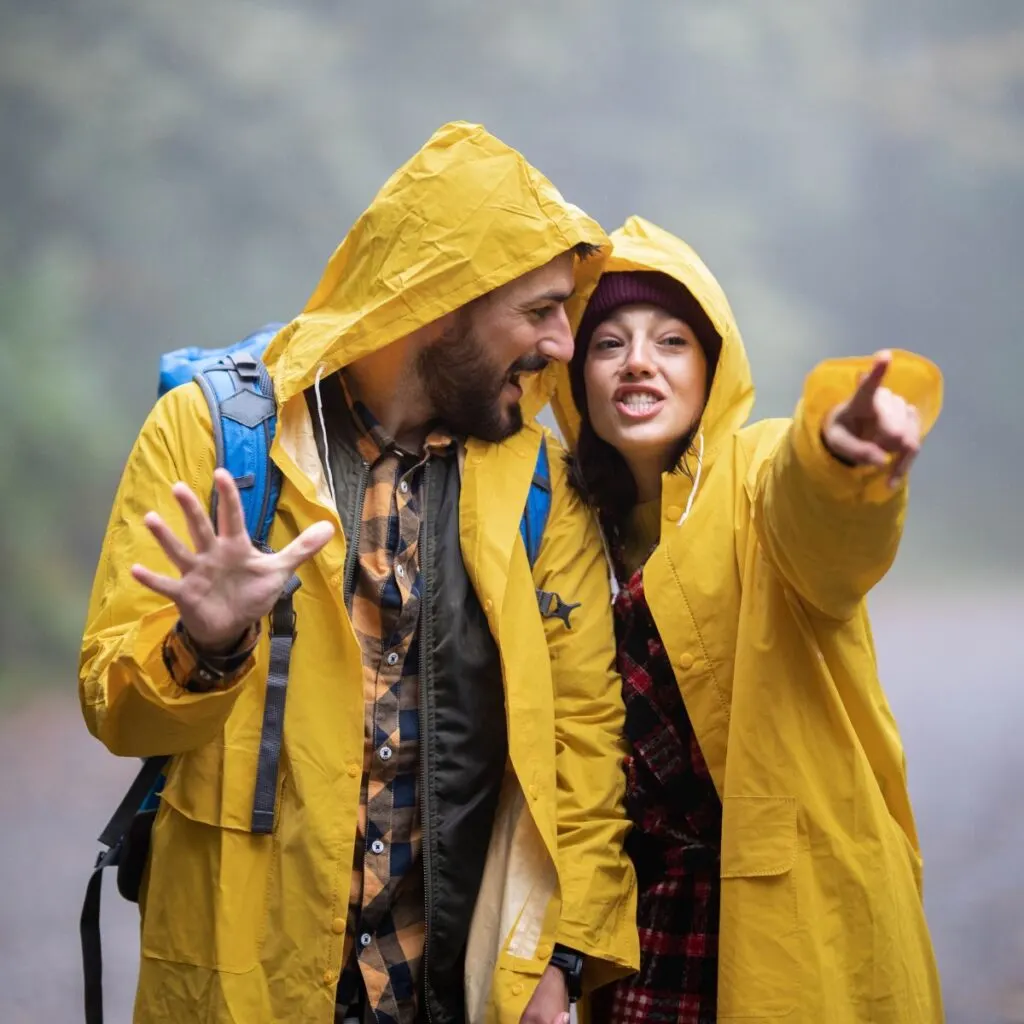 Couple having a rainy day date going geocaching