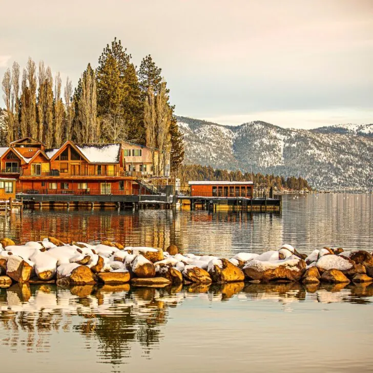 Lake Tahoe in a warm ambiance surrounded by multiple cabins perfect as one of the places for cheap weekend getaways for couples