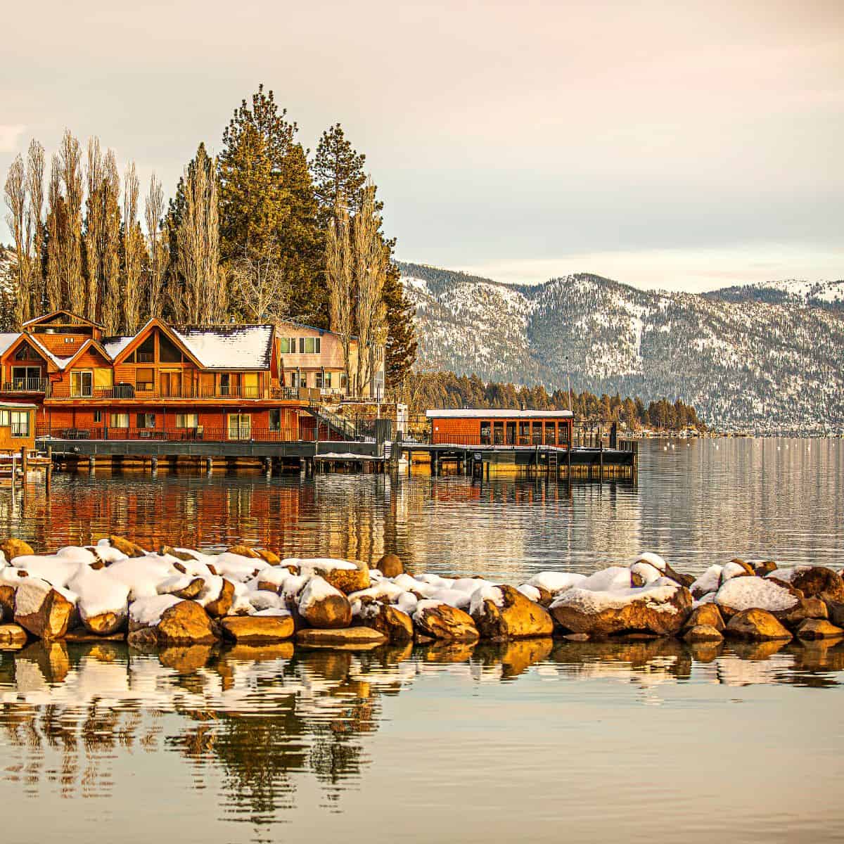 Lake Tahoe in a warm ambiance surrounded by multiple cabins perfect as one of the places for cheap weekend getaways for couples