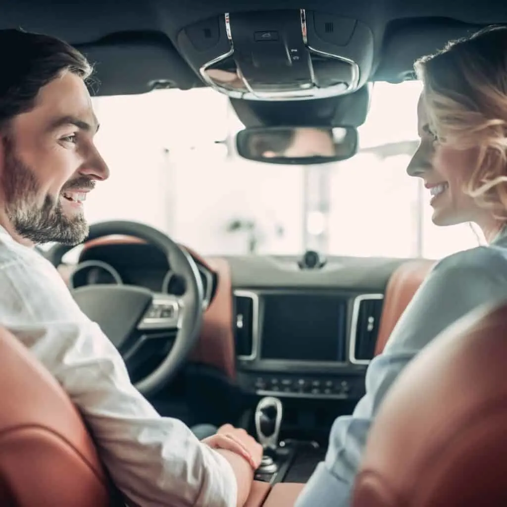 A couple in a car asking would you rather questions about relationships