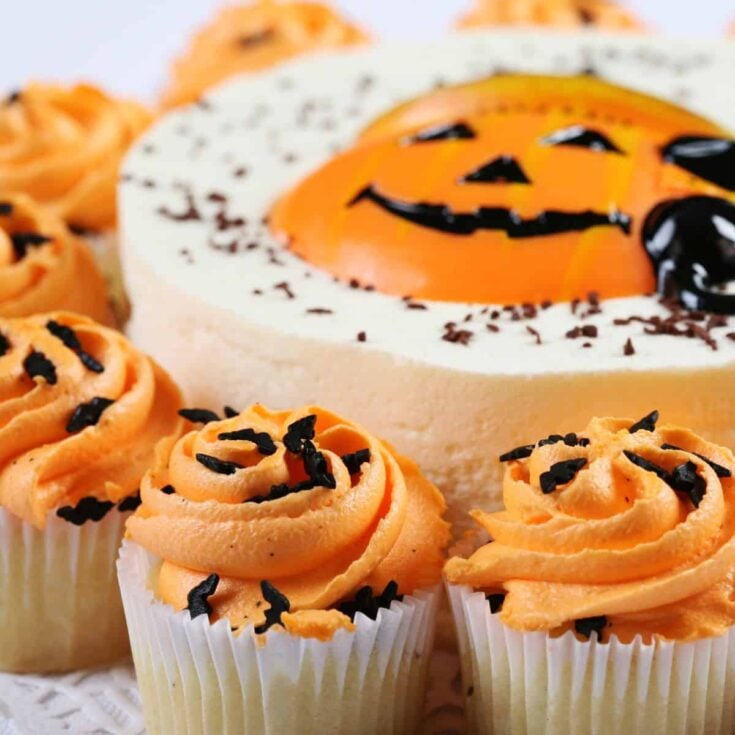 Pumpkin themed cake and cupcakes prepared as Halloween desserts