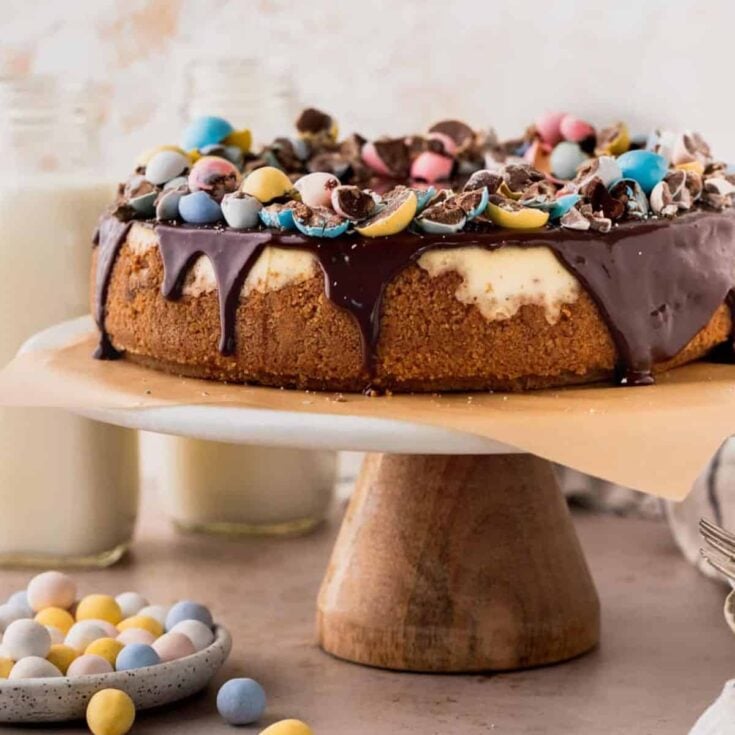 Easter egg cheesecake topped with chocolate syrup and colorful little eggs