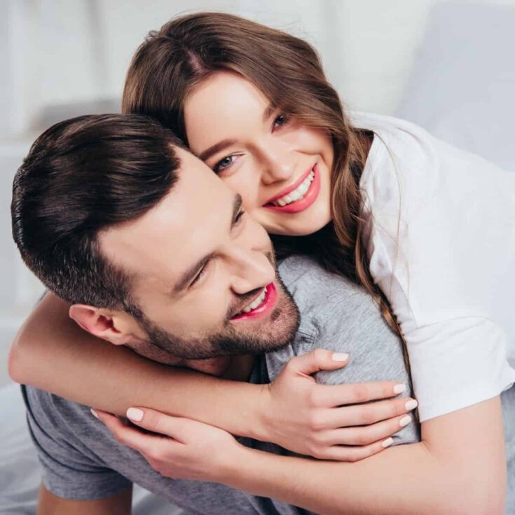 A couple hugging while asking each other intimate questions for couples