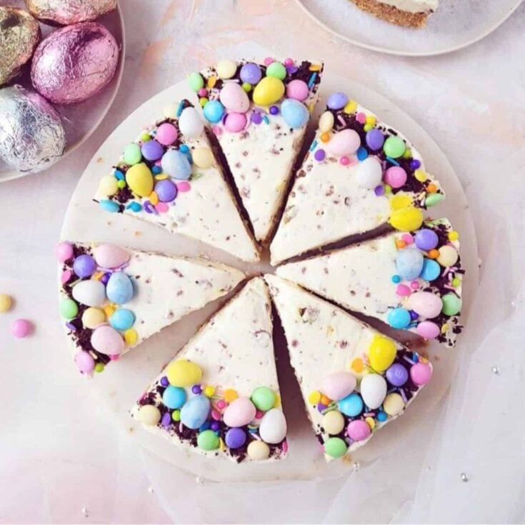 No bake Easter cheesecake topped with colorful little chocolate eggs