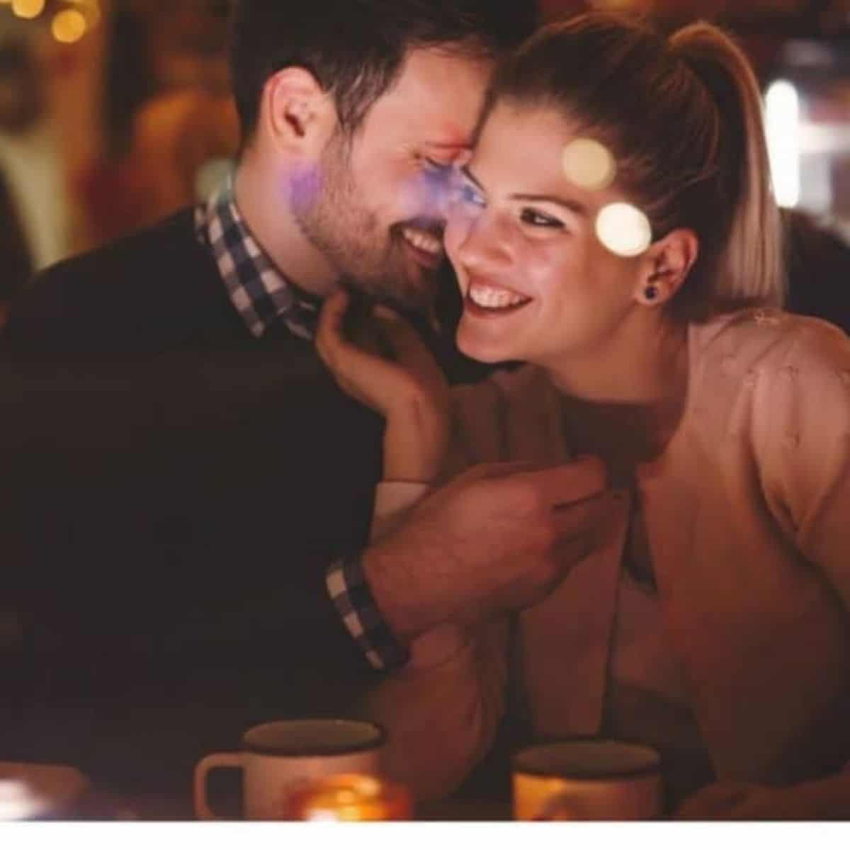A couple having dinner and being intimate while asking each other date night questions