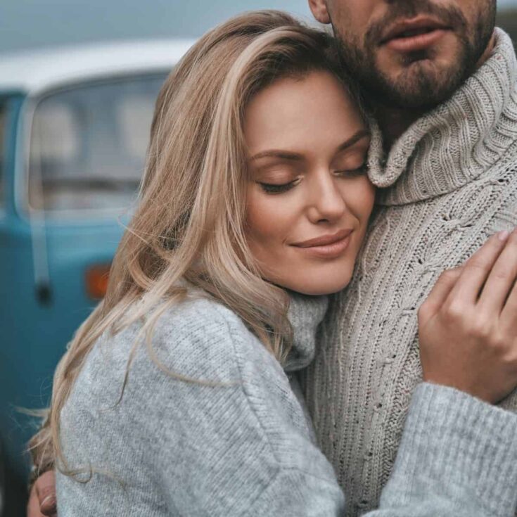 A couple hugging each other while asking each other romantic questions for couples