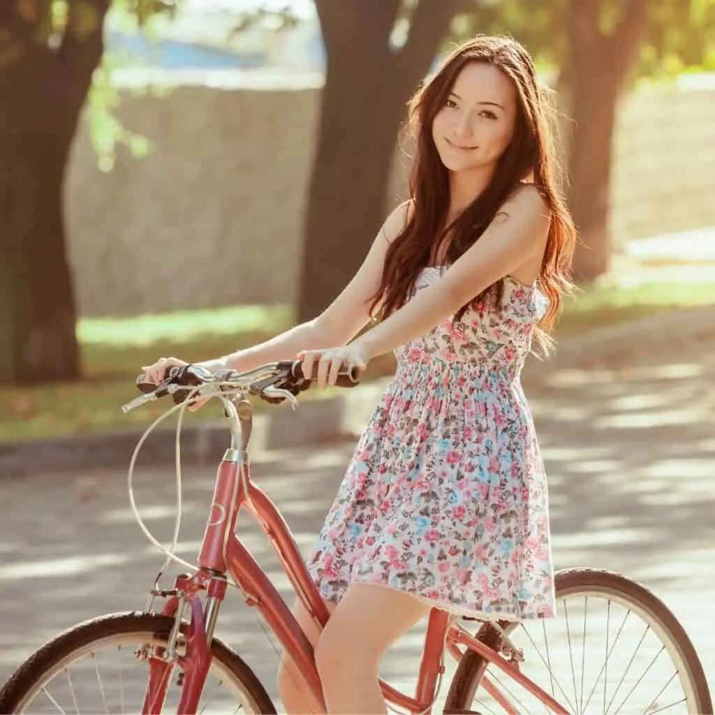 A teen girl wheeling her bike: date ideas for 15 year olds.
