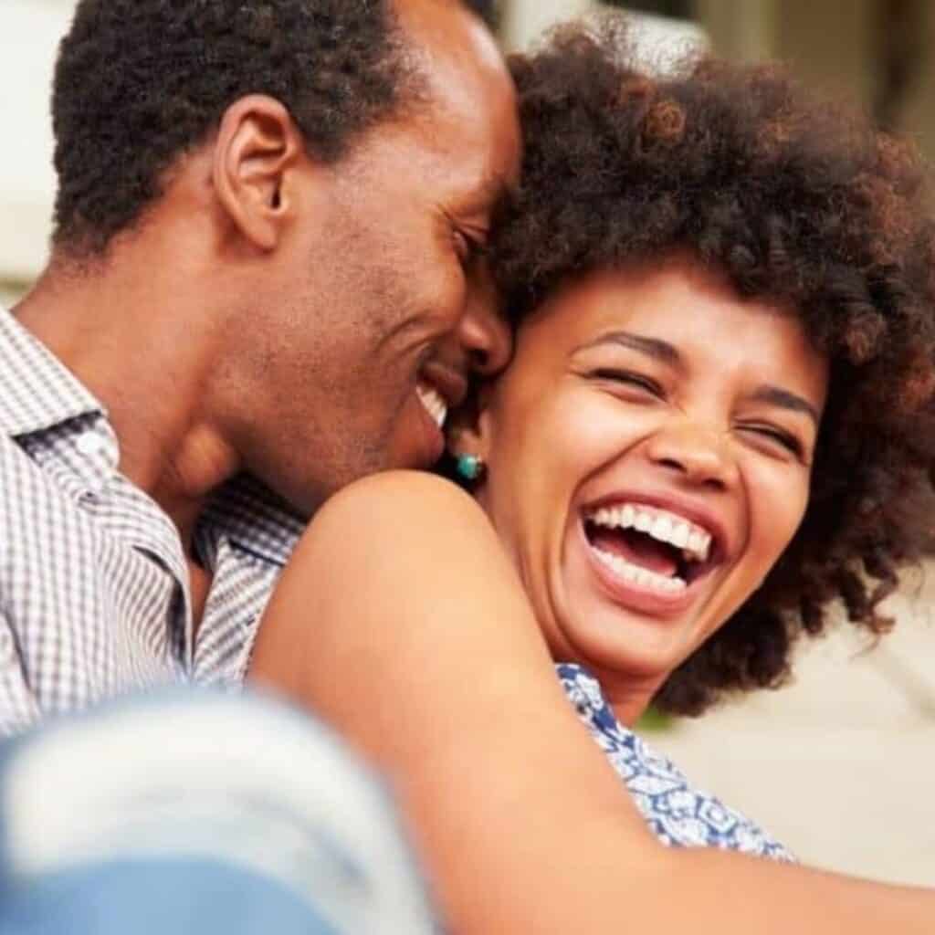 A couple laughing together after asking some of these Never have I ever questions.