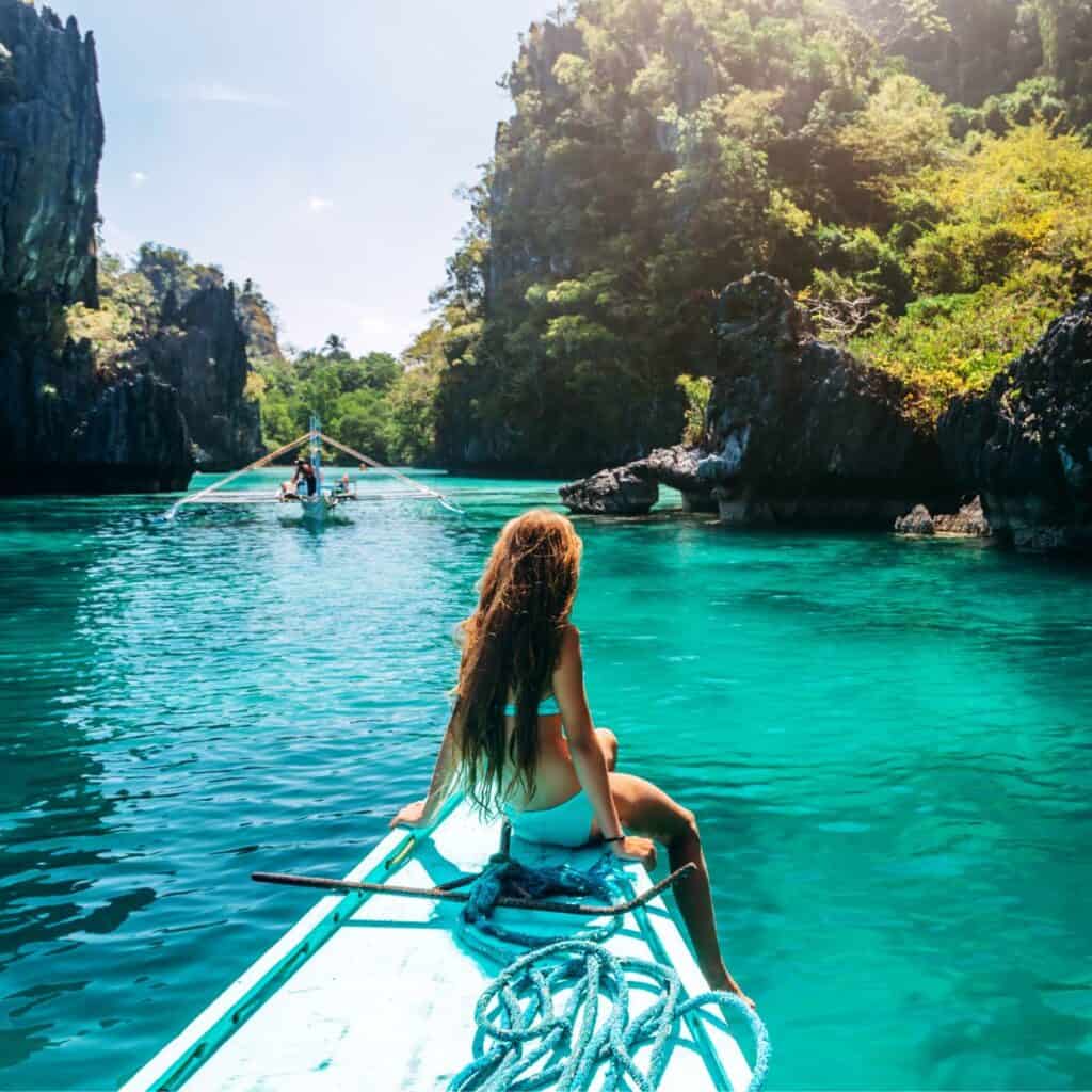 A woman on a boat roaming around a tropical island