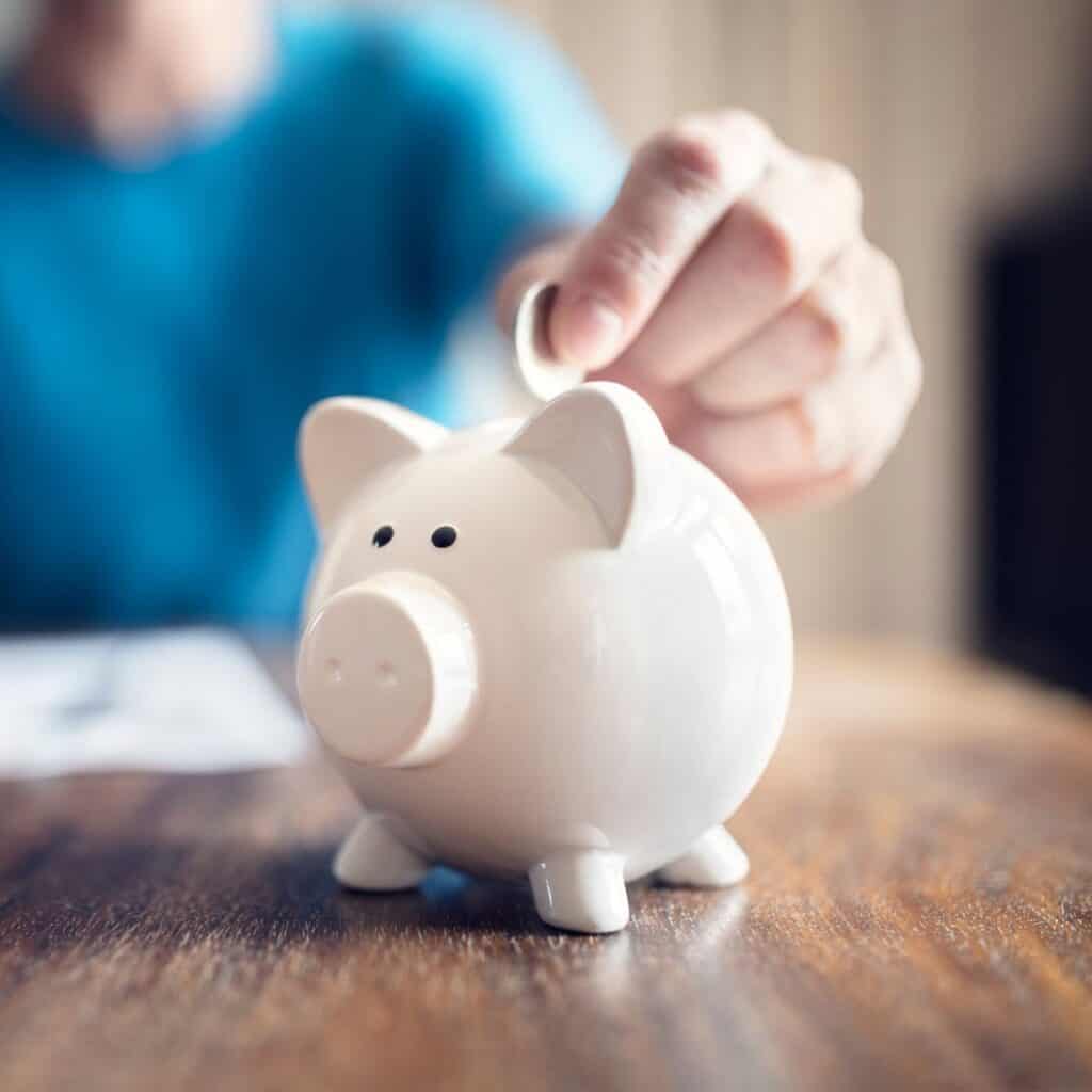 A man putting money into a piggy bank