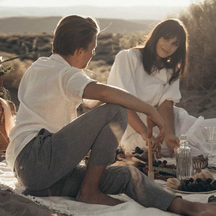 A couple having a picnic together after reading these cheap date ideas