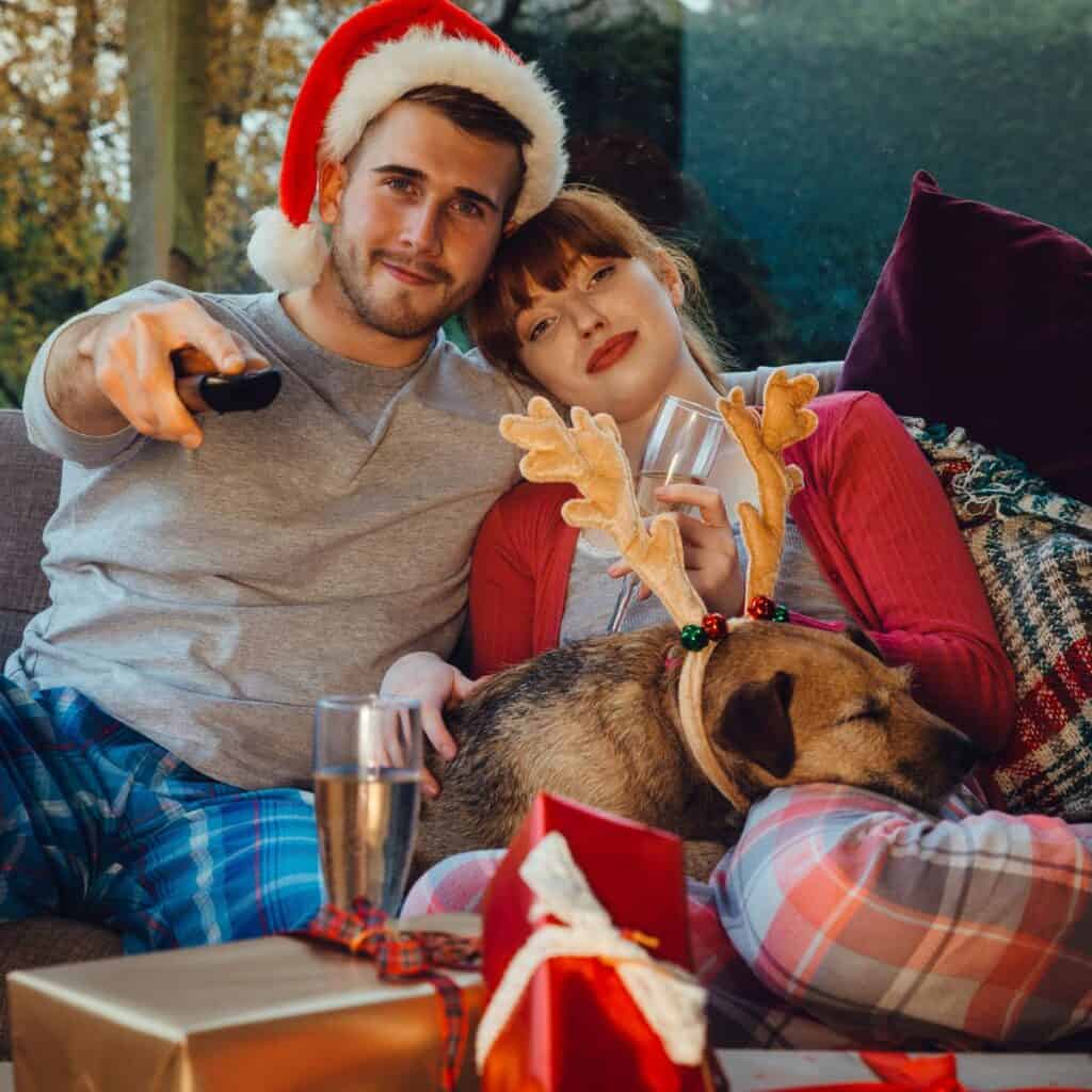 A lovely couple on the couch watching romantic Christmas movies together