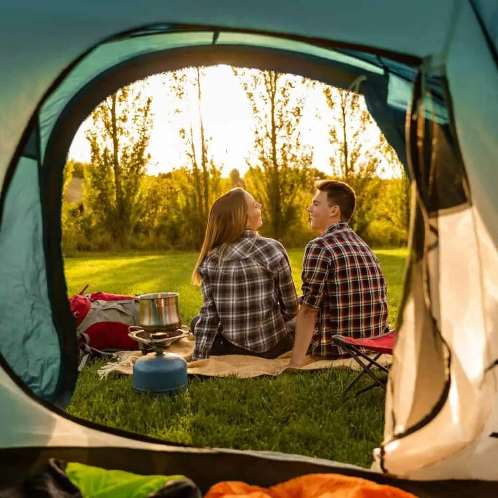 A couple bonding outside their tent: Social hobbies for couples