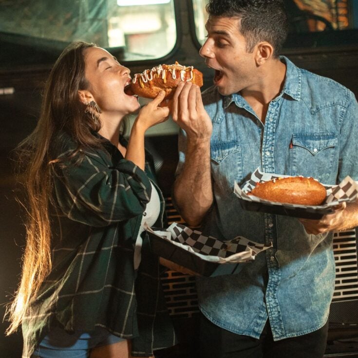 A happy couple eating together after reading these quick date ideas