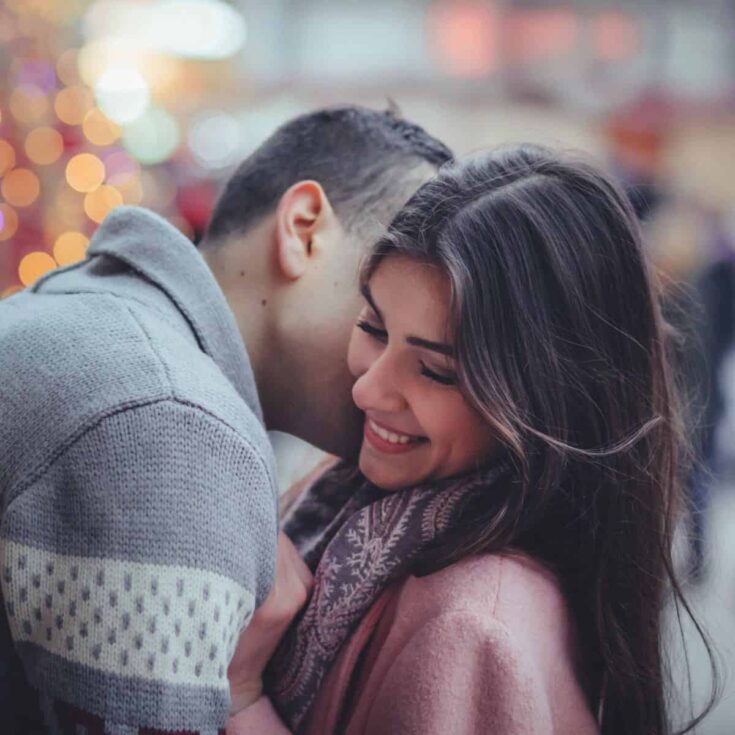 A couple being intimate, with the man leaning towards the girl telling deep love messages for her