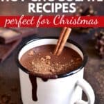 A enamel mug filled with hot chocolate and the text overlay, 25 tasty hot chocolate recipes perfect for Christmas.