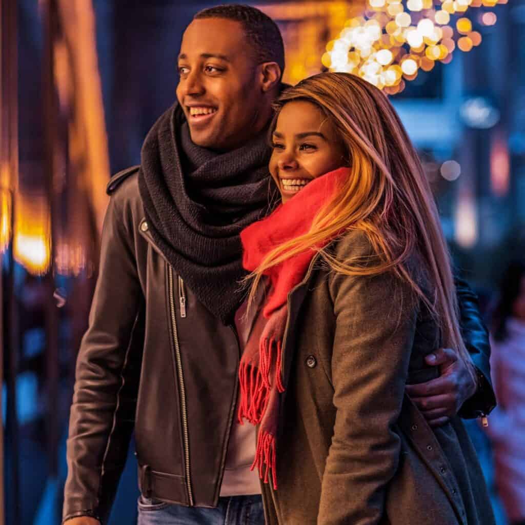 A couple shopping outside together after reading these Christmas date ideas