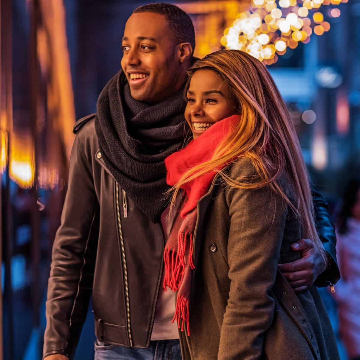 A couple shopping outside together after reading these Christmas date ideas
