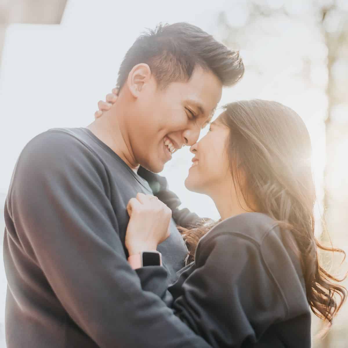 A couple looking at each other happily in love after using these relationship affirmations