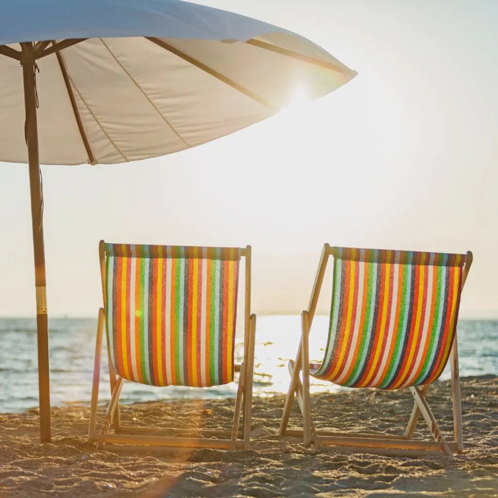 Deck chairs on beach a free summer bucket list idea for couples