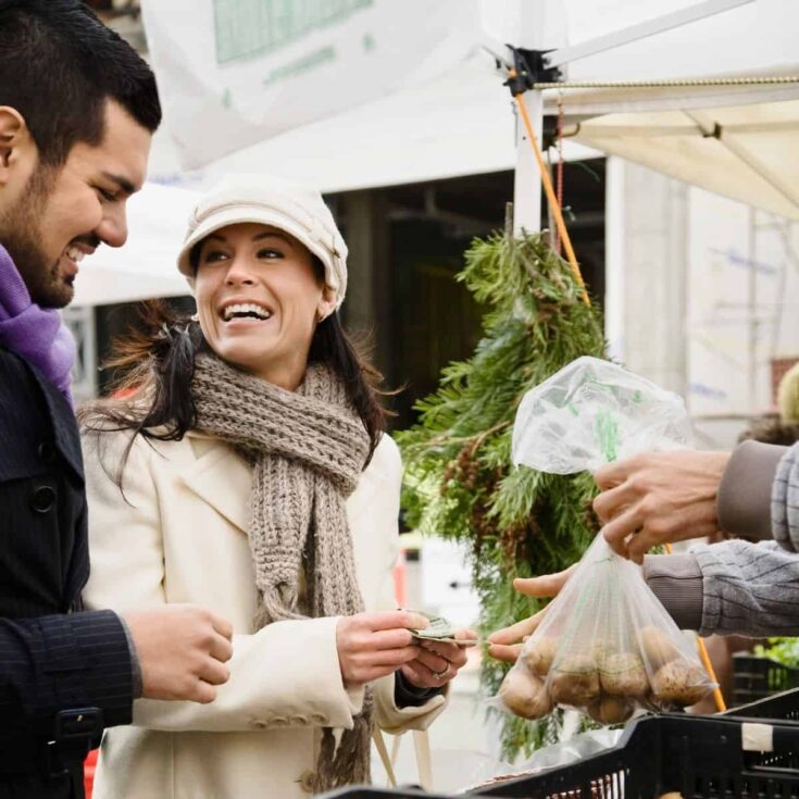 Couple at a farmers market as one of these eco friendly date ideas