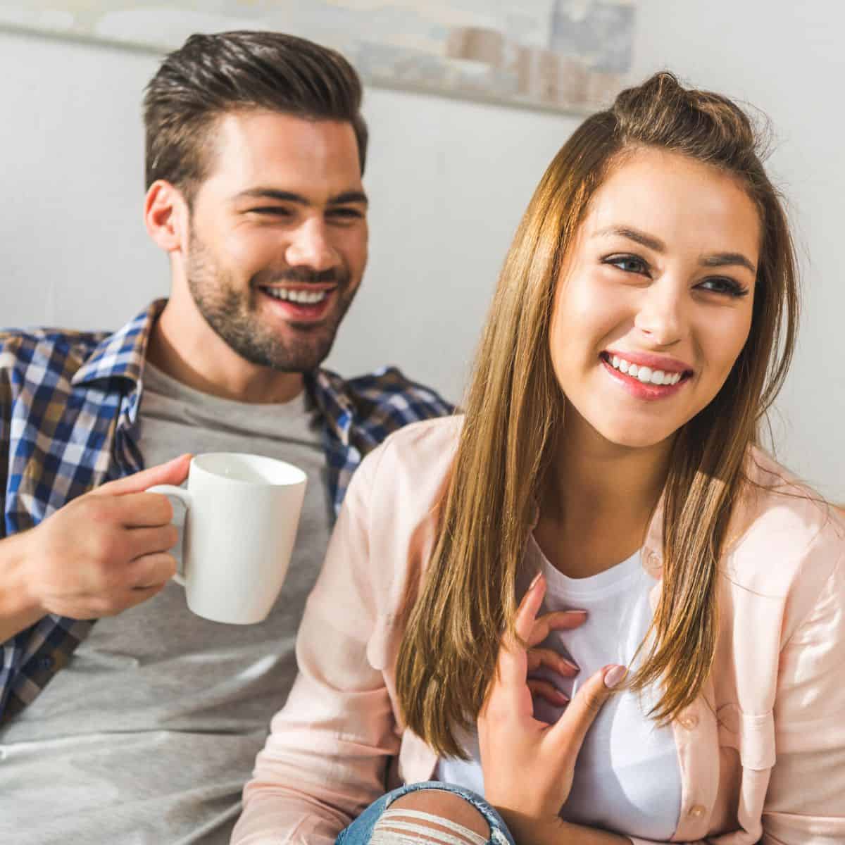 Couple laughing asking favorite things questions for couples
