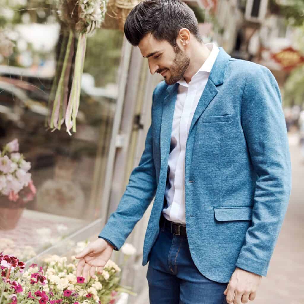 A man choosing the perfect anniversary flowers while also considering his budget