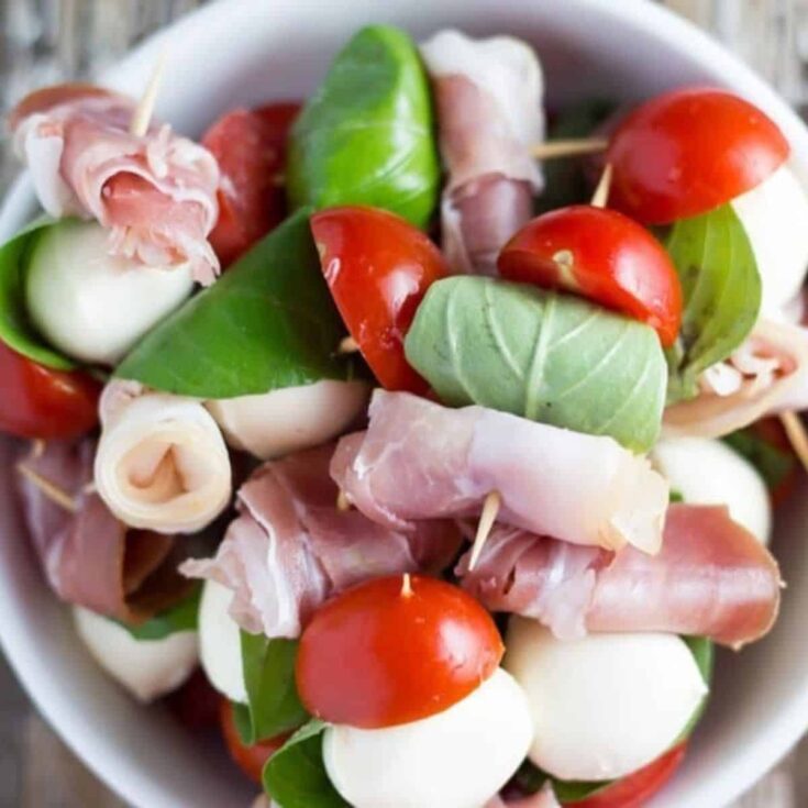 A bowl of prosciutto and mozzarella skewers perfect as a Super bowl appetizer