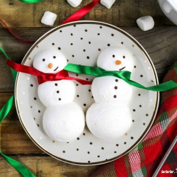 A plate of snowmen meringue cookies perfect to serve as Christmas cookies
