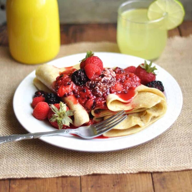 A plate of berry compote cr&ecirc;pes served on the table