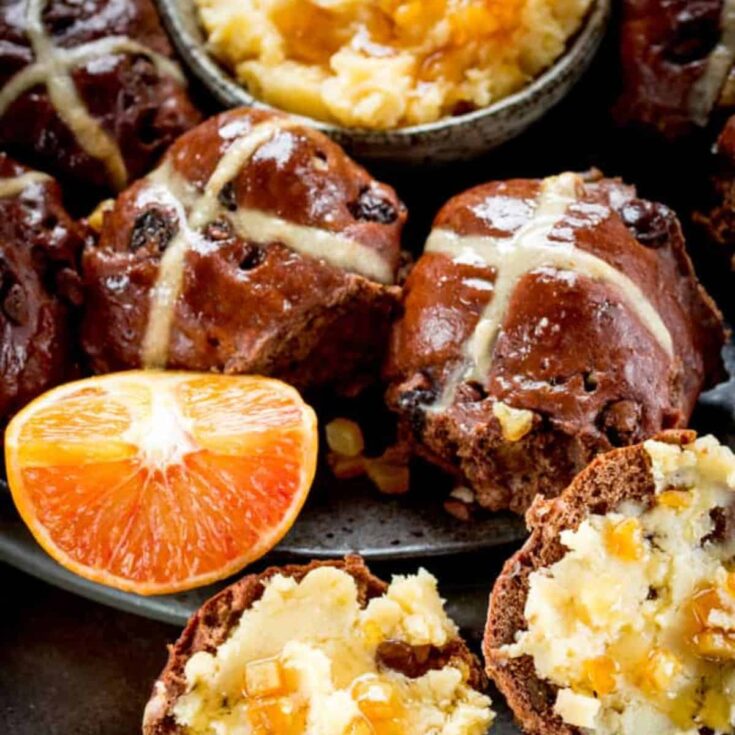 A set of chocolate orange hot cross buns with orange honey butter