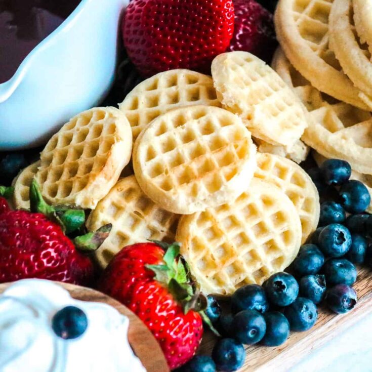 A delicious waffle board filled with strawberries, blueberries, and waffles