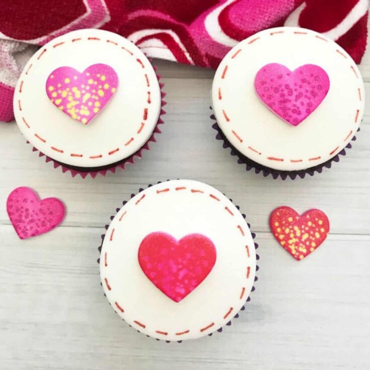 A set of love stitch Valentines Day cupcakes with heart toppings