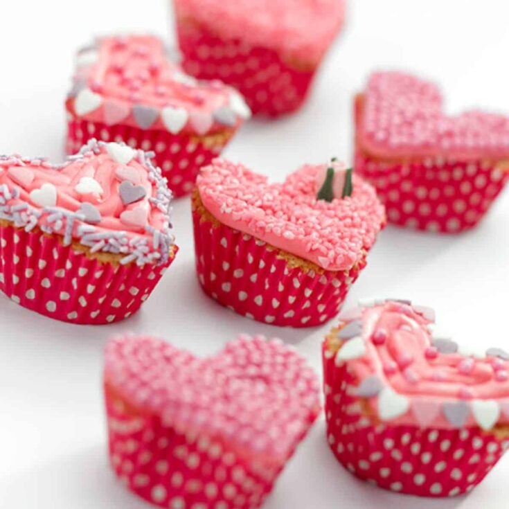 A plate of pink heart shaped Valentines Day cupcakes