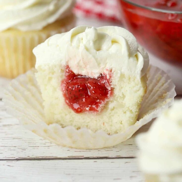 An appetizing strawberry filled Valentines Day cupcake
