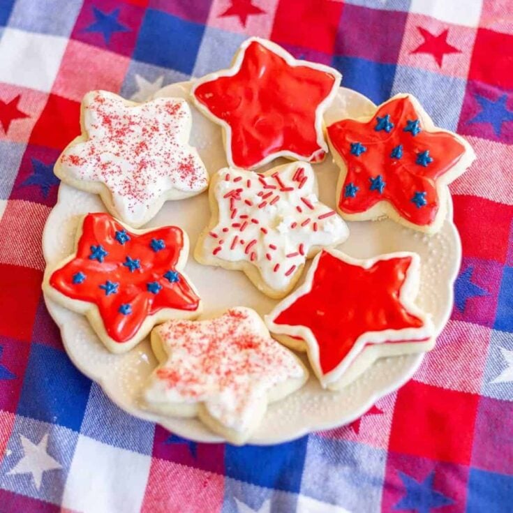 A plate of 4th of July sour cream sugar cookies with cream cheese frosting, perfect as Patriotic Cookies