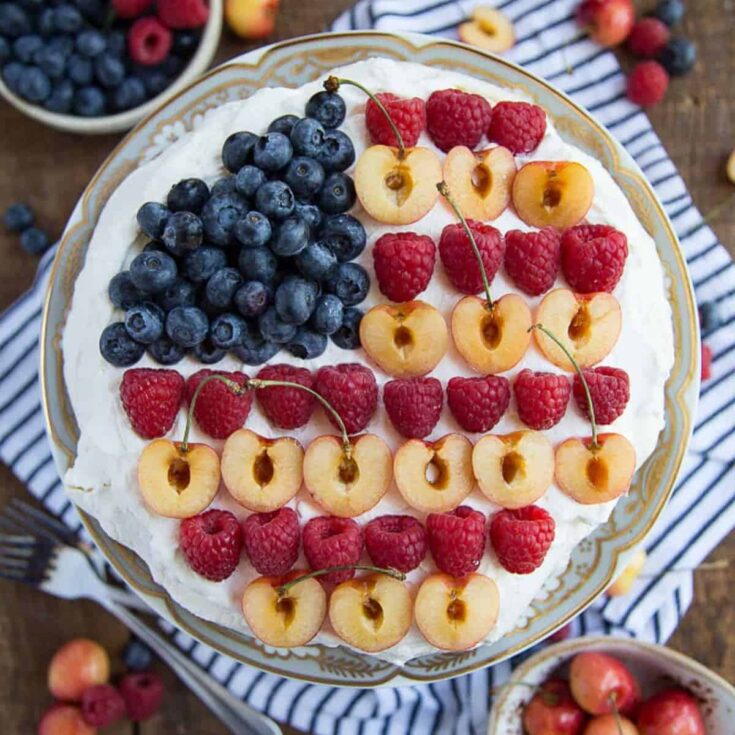 A plate of Berry pavlova with flag design perfect as one of the Patriotic Desserts