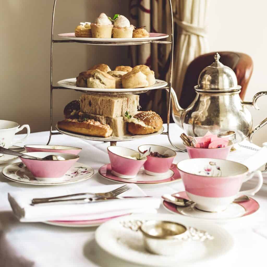 An afternoon tea party with tea set and food on the table: how do you eat afternoon tea