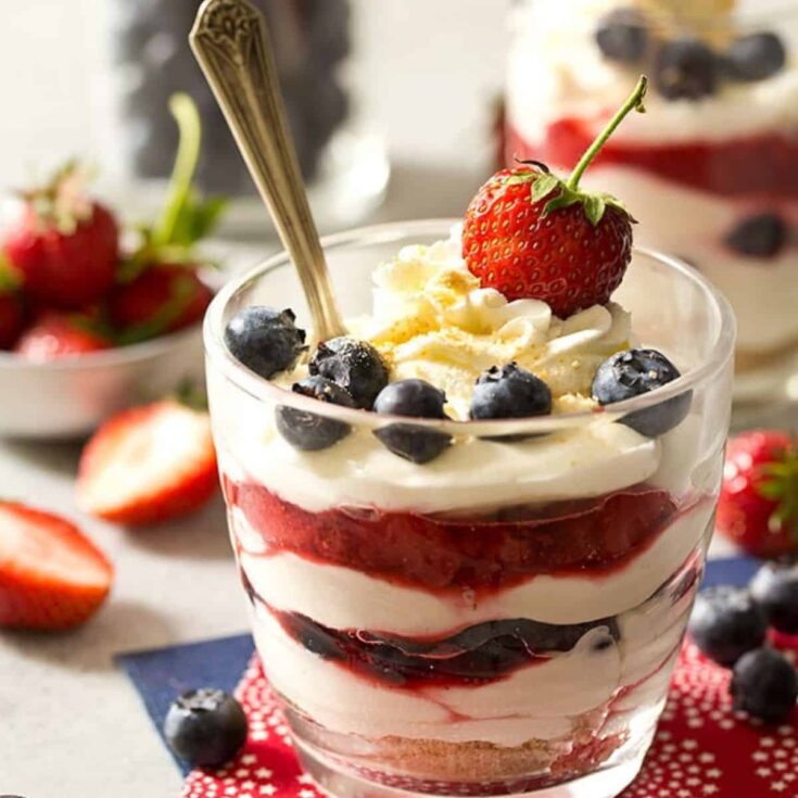 A glass of a no bake cheesecake with fresh berries Patriotic Dessert