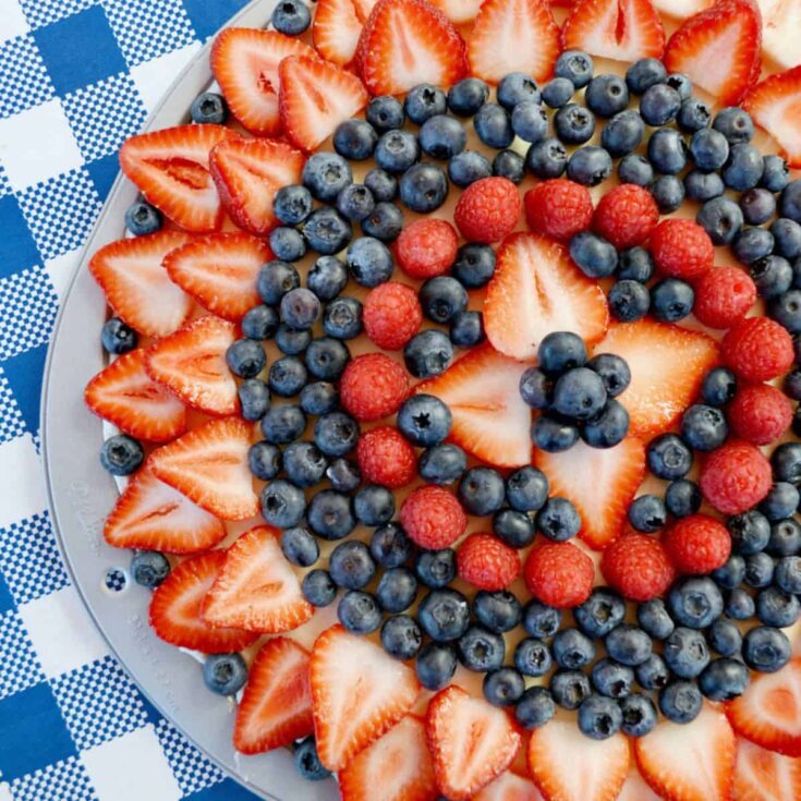 A plate of sugar cookie fruit pizza with fresh berries Patriotic Dessert