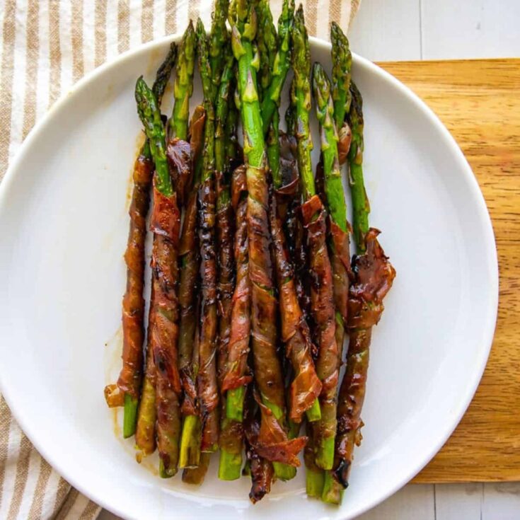 A plate of grilled prosciutto wrapped asparagus cookout sides