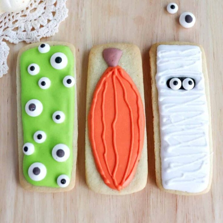 Creative Halloween sugar cookies with monster eyes, pumpkin, and a mummy
