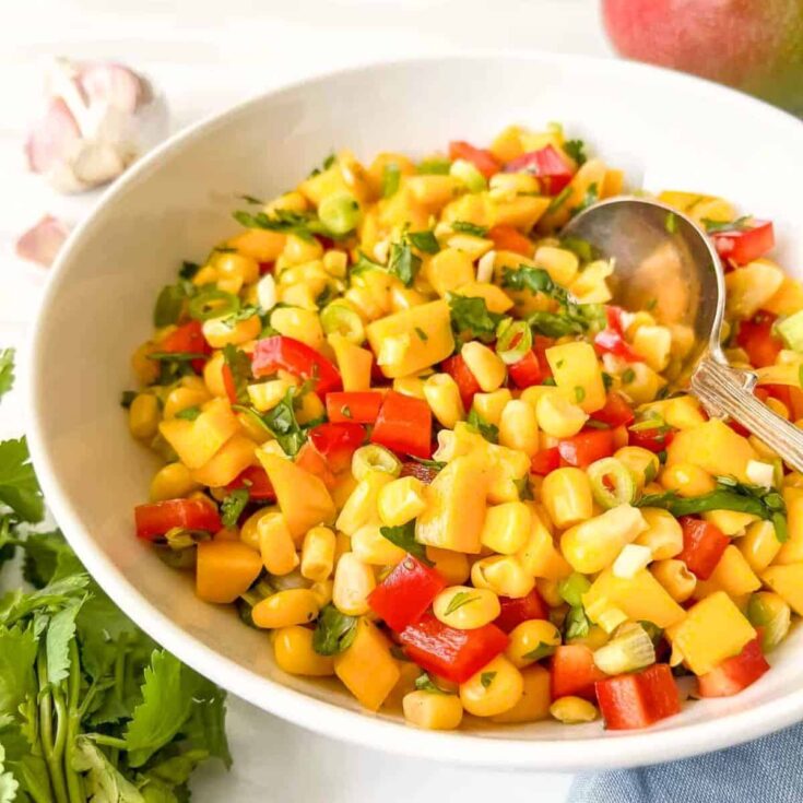 A bowl of mango corn salsa cookout side