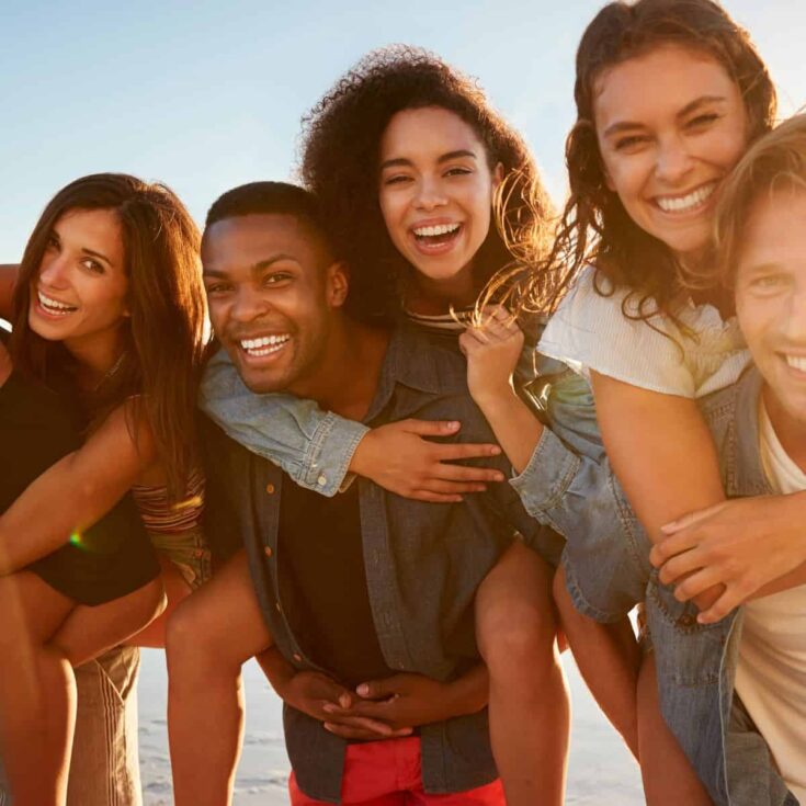 Couples posing for the camera and smiling on s group date (group date ideas)